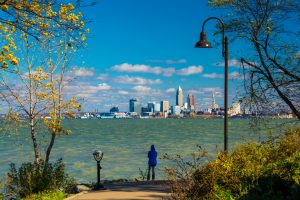 Woman Looking At Cleveland Skyline From Park