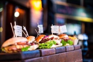 Freshly flame grilled burgers displayed in a row